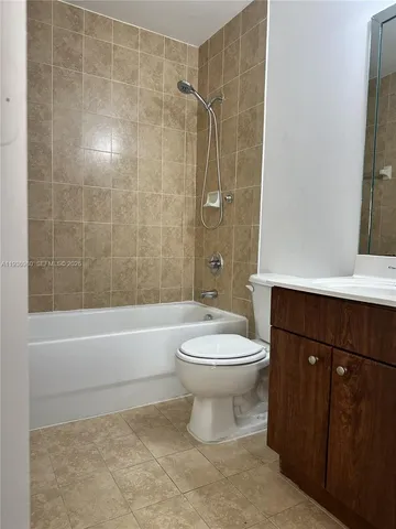 a bathroom with a toilet a sink and shower