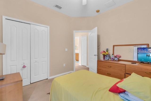 5120 Shale Ridge Trail Orlando, FL 32818 - Photo 12 of 15 a bedroom with a bed and a dresser