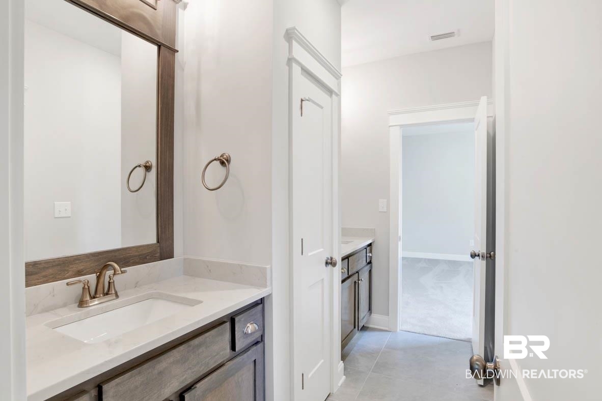 393 Garrison Boulevard Fairhope, AL 36532 - Photo 20 of 40 Bathroom featuring tile patterned floors and vanity