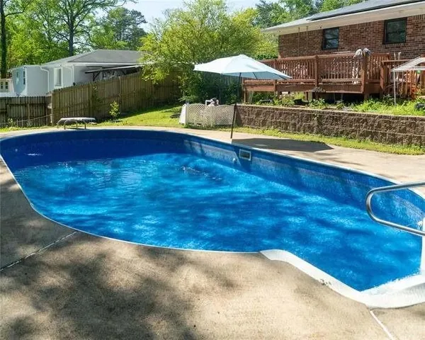 a view of swimming pool with seating space