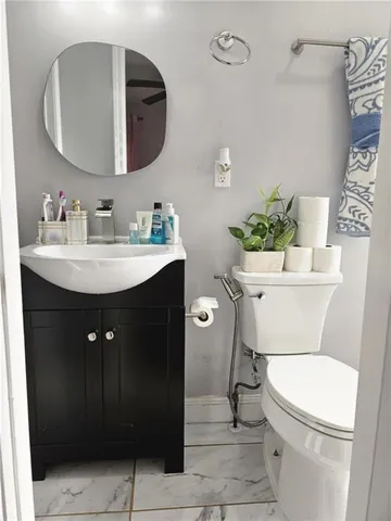 a bathroom with a sink mirror vanity and toilet