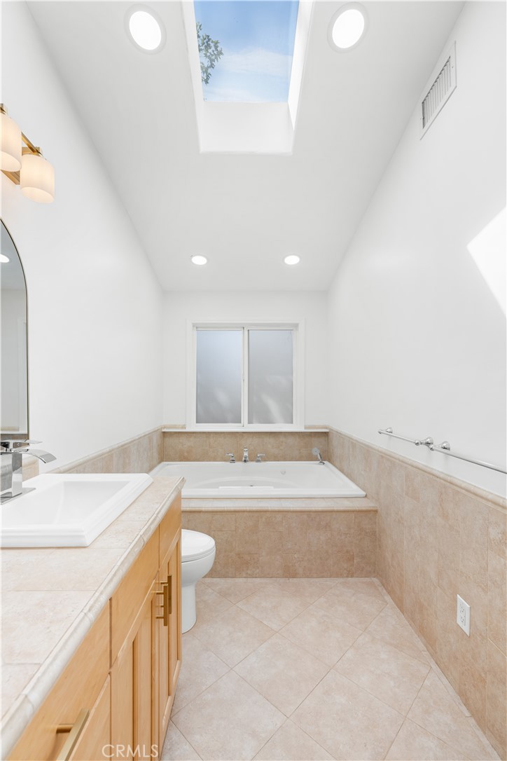 26096 Adamor Road Calabasas, CA 91302 - Photo 35 of 61 Primary bathroom looking towards 6' jetted tub and frosted window.
