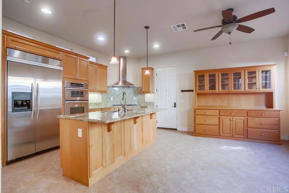 421 North Cedros Avenue Solana Beach, CA 92075 - Photo 15 of 54 a kitchen with stainless steel appliances granite countertop a sink and a refrigerator