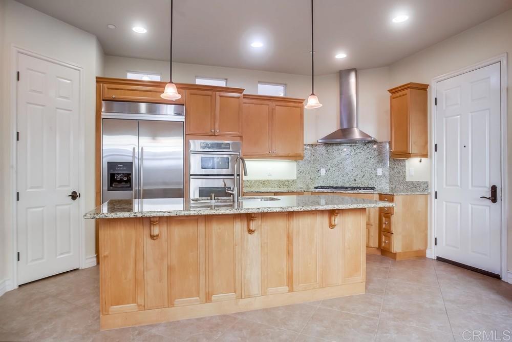 421 North Cedros Avenue Solana Beach, CA 92075 - Photo 16 of 54 a kitchen with granite countertop a refrigerator and a sink