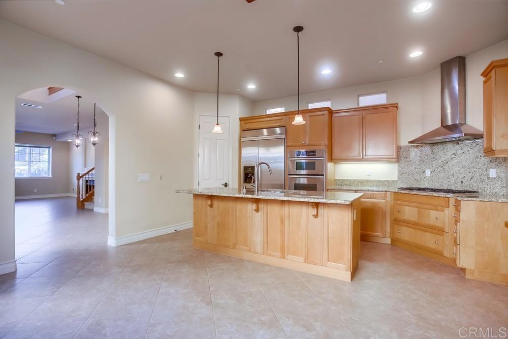 421 North Cedros Avenue Solana Beach, CA 92075 - Photo 17 of 54 a large kitchen with granite countertop a large counter top a sink stainless steel appliances and cabinets