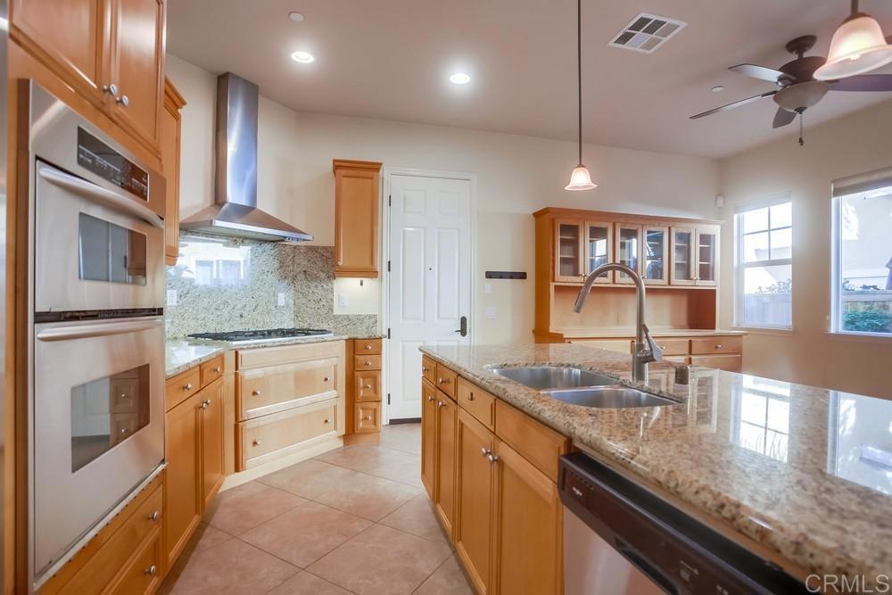 421 North Cedros Avenue Solana Beach, CA 92075 - Photo 20 of 54 a kitchen with stainless steel appliances granite countertop a sink counter space cabinets and a stove