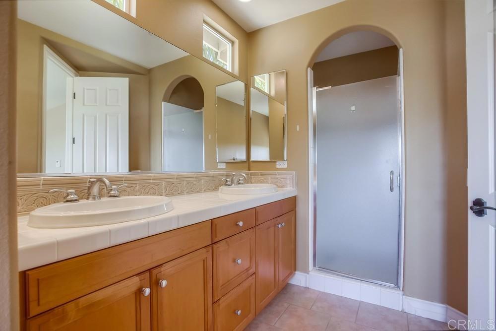 421 North Cedros Avenue Solana Beach, CA 92075 - Photo 30 of 54 a bathroom with a double vanity sink and a mirror
