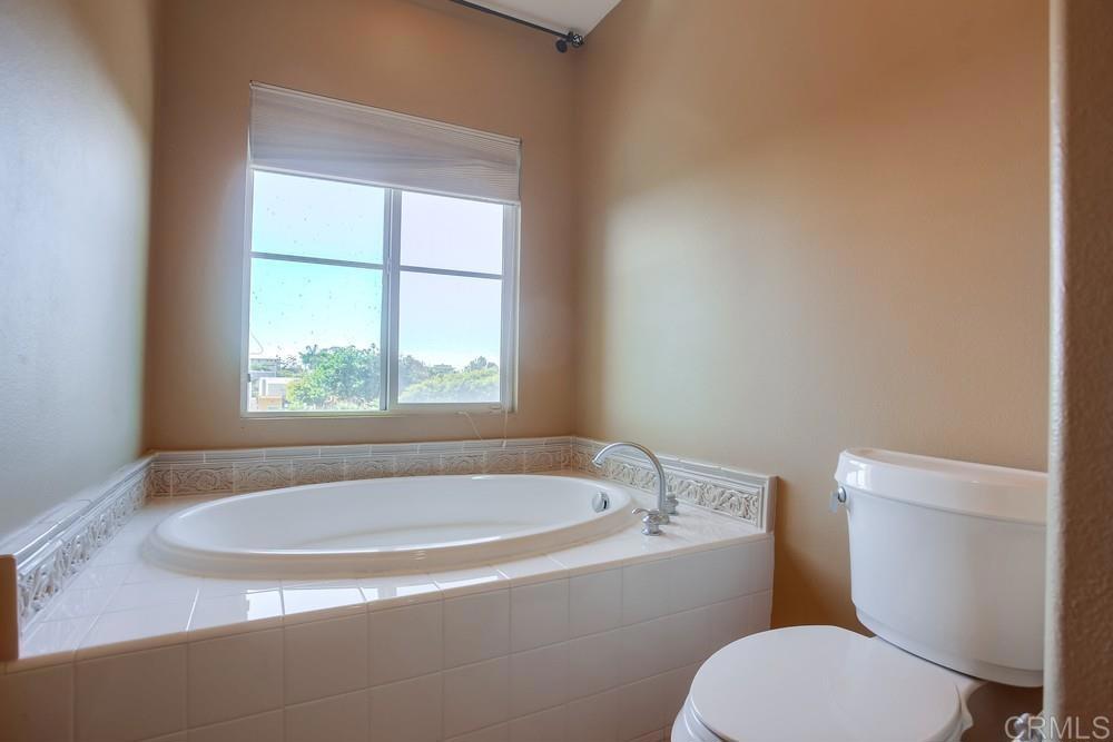 421 North Cedros Avenue Solana Beach, CA 92075 - Photo 32 of 54 a white bath tub sitting next to a toilet