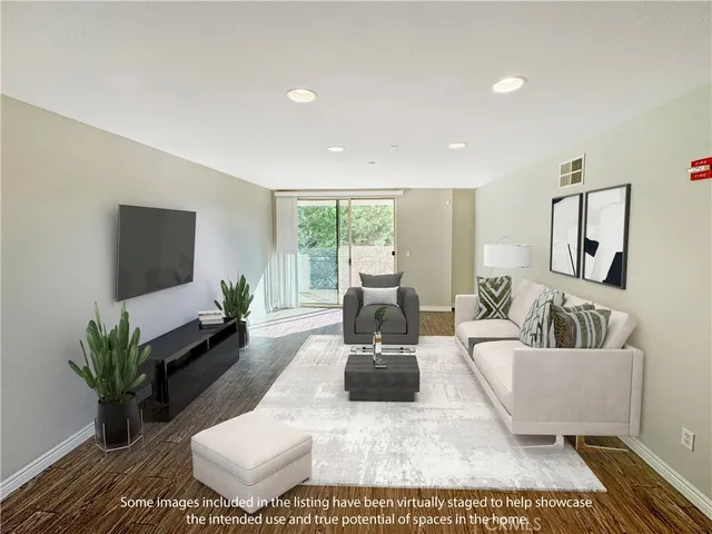 a living room with furniture wooden floor and a flat screen tv