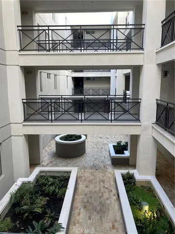 a view of a patio with table and chairs potted plants