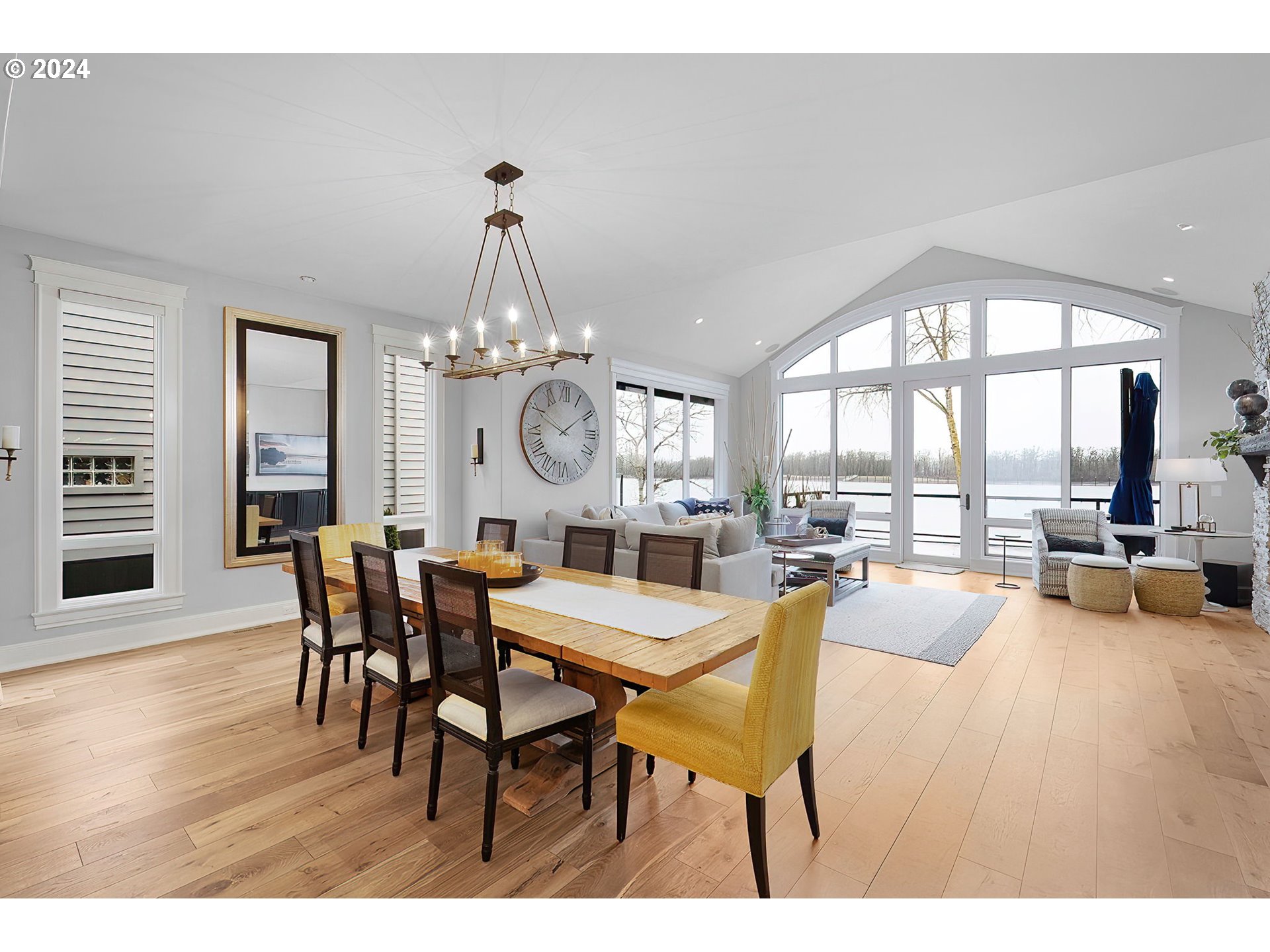 15421 Southeast Rivershore Drive Vancouver, WA 98683 - Photo 10 of 39 a view of a dining room with furniture large windows and wooden floor