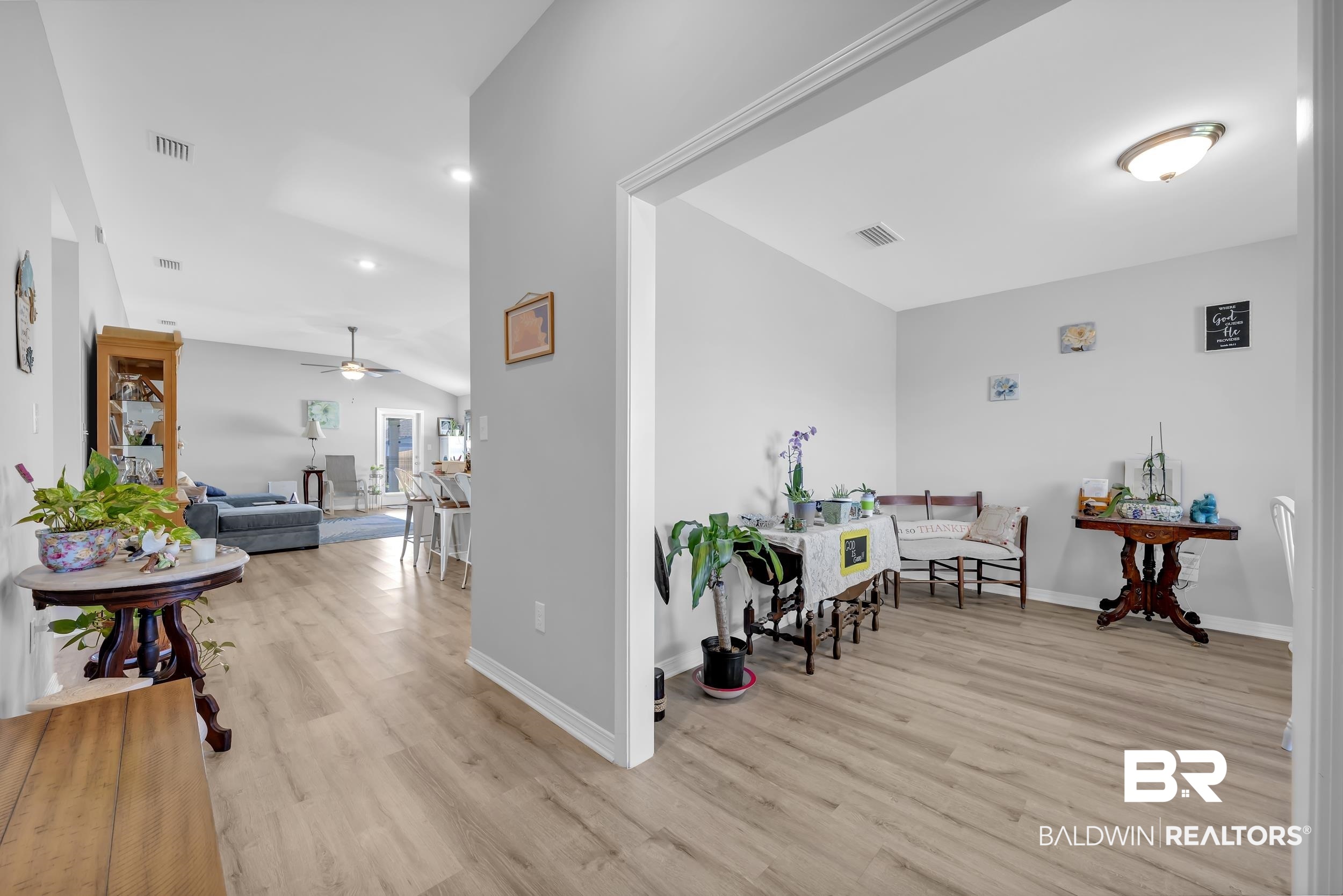 1228 Caper Avenue Foley, AL 36535 - Photo 5 of 54 Open-concept interior featuring wood-finish flooring, vaulted ceilings, recessed lighting, and light gray wall paint