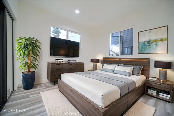 a bedroom with a bed and a flat screen tv