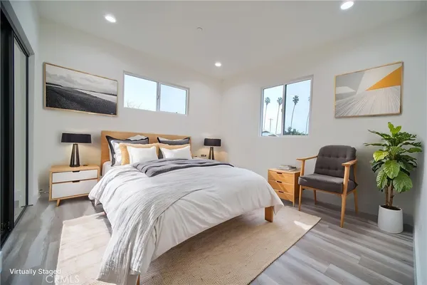 a bedroom with a bed and a potted plant