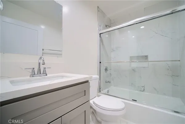 a bathroom with a sink a toilet and a bathtub