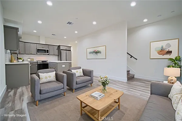 a living room with furniture and kitchen view