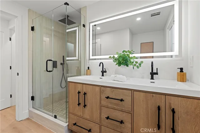 a bathroom with a shower sink and mirror