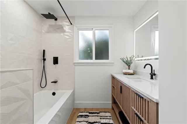 a bathroom with a sink a mirror and shower