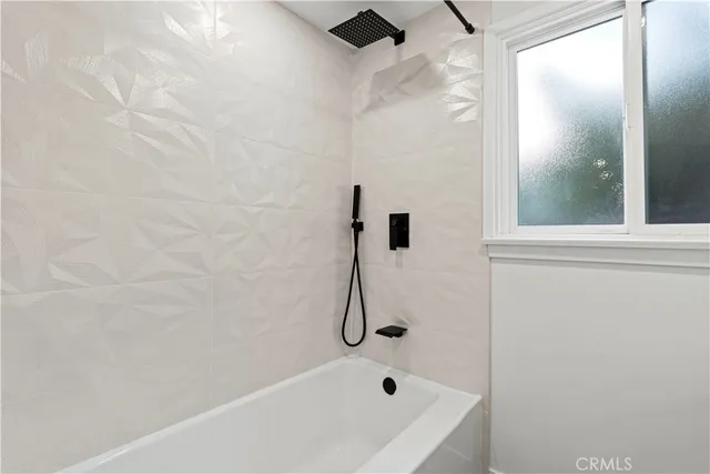 a bathroom with a bath tub and shower