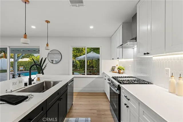 a kitchen that has a sink and a stove