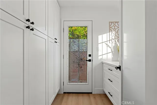 a view of an entryway with wooden floor