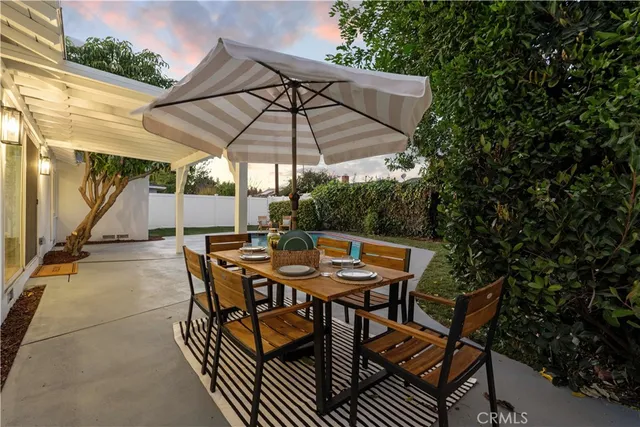 a view of a house with pool and a yard