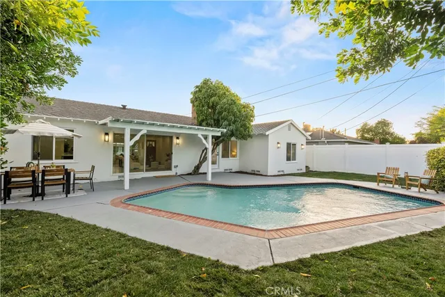 a view of a porch with chairs and backyard