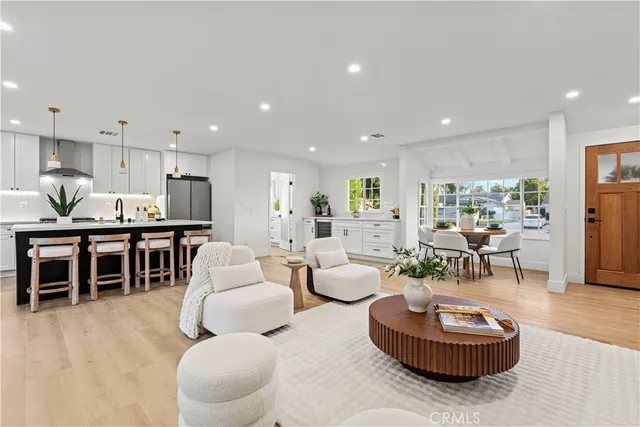 a living room with furniture and a kitchen