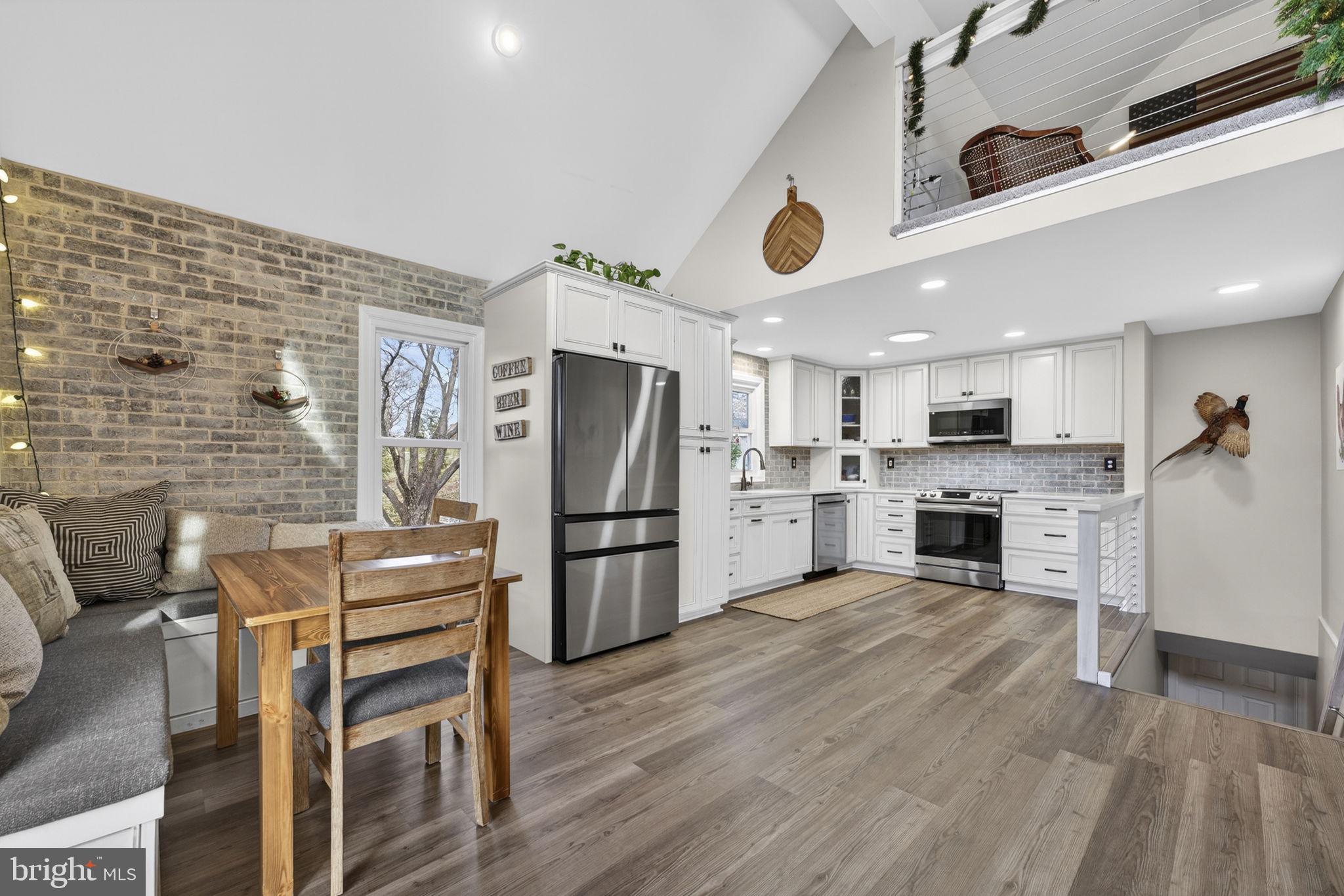 9666 Springs Road Warrenton, VA 20186 - Photo 22 of 77 a kitchen with stainless steel appliances kitchen island granite countertop a refrigerator and a stove top oven