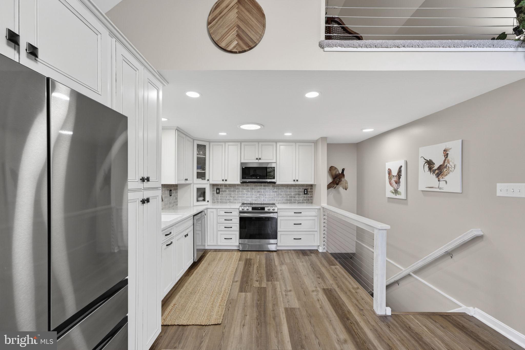 9666 Springs Road Warrenton, VA 20186 - Photo 24 of 77 a kitchen with stainless steel appliances a stove a refrigerator and white cabinets