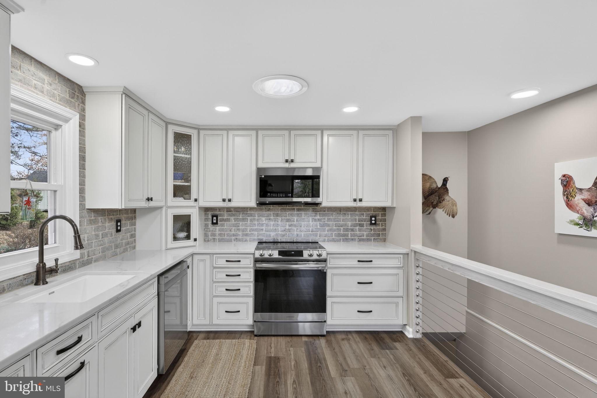 9666 Springs Road Warrenton, VA 20186 - Photo 27 of 77 a kitchen with granite countertop a sink cabinets and stainless steel appliances