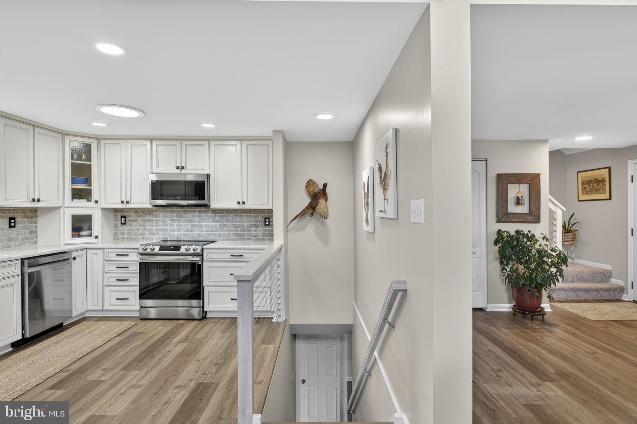 9666 Springs Road Warrenton, VA 20186 - Photo 30 of 77 a kitchen with granite countertop a refrigerator stove and sink
