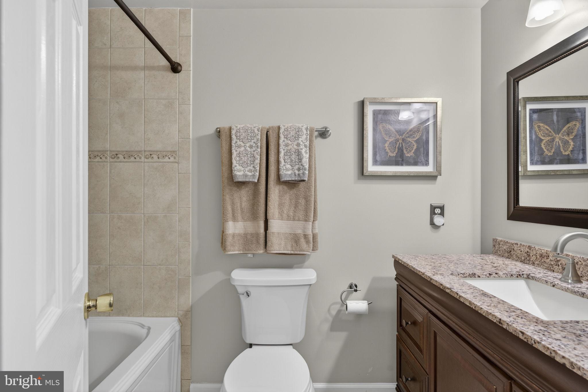 9666 Springs Road Warrenton, VA 20186 - Photo 43 of 77 a bathroom with a granite countertop sink toilet and shower