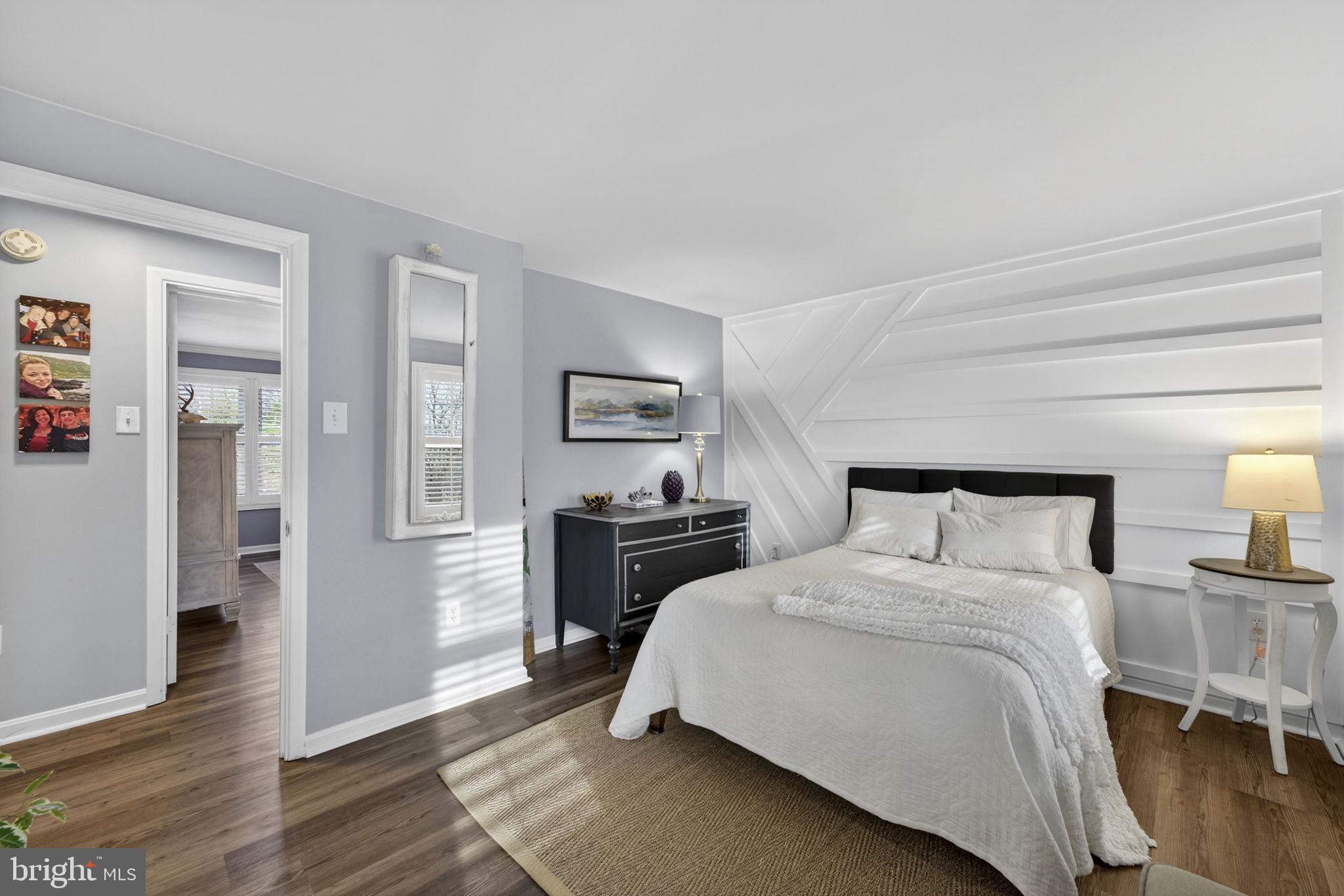 9666 Springs Road Warrenton, VA 20186 - Photo 46 of 77 a bedroom with a bed and wooden floor