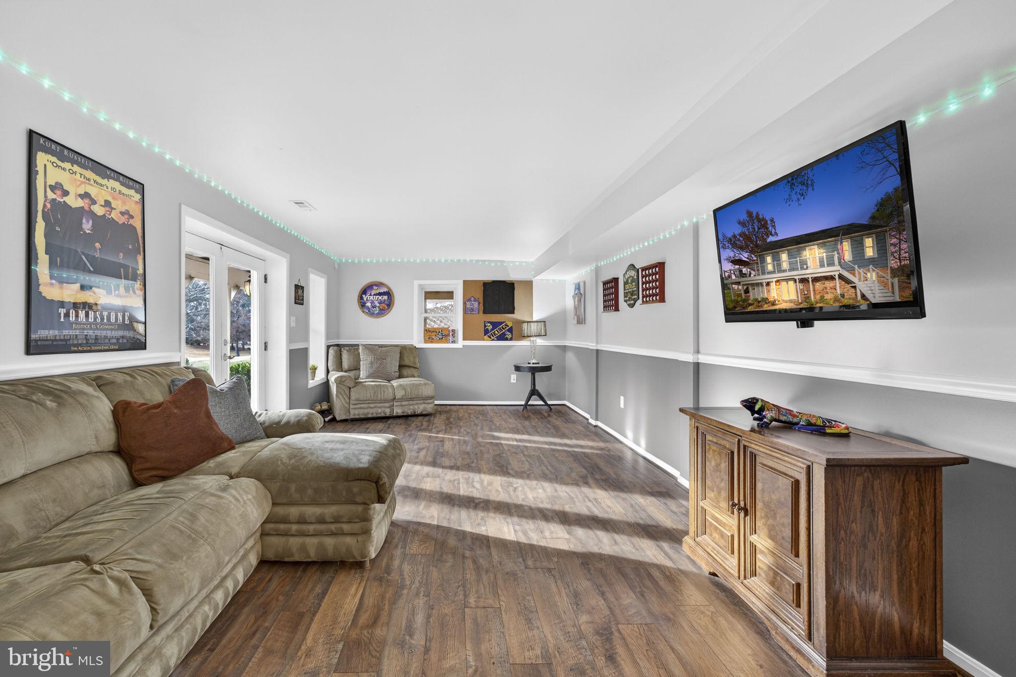 9666 Springs Road Warrenton, VA 20186 - Photo 58 of 77 a living room with furniture and a flat screen tv
