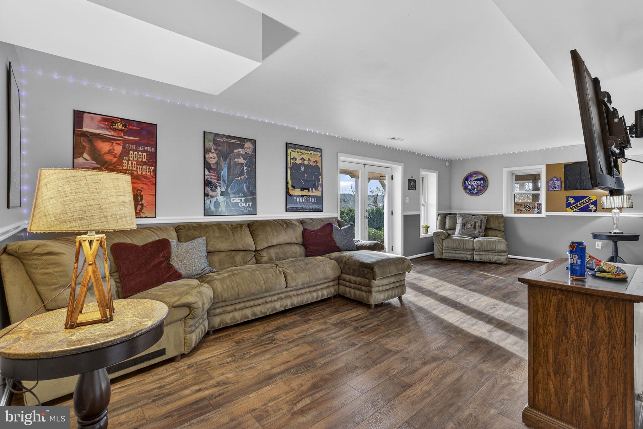 9666 Springs Road Warrenton, VA 20186 - Photo 59 of 77 a living room with furniture and a flat screen tv