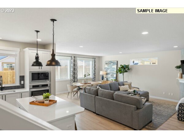 8727 North 3rd Street, Unit 38 Ridgefield, WA 98642 - Photo 33 of 33 a living room with furniture and a wooden floor