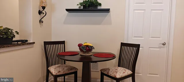 a view of a dining room with furniture and window