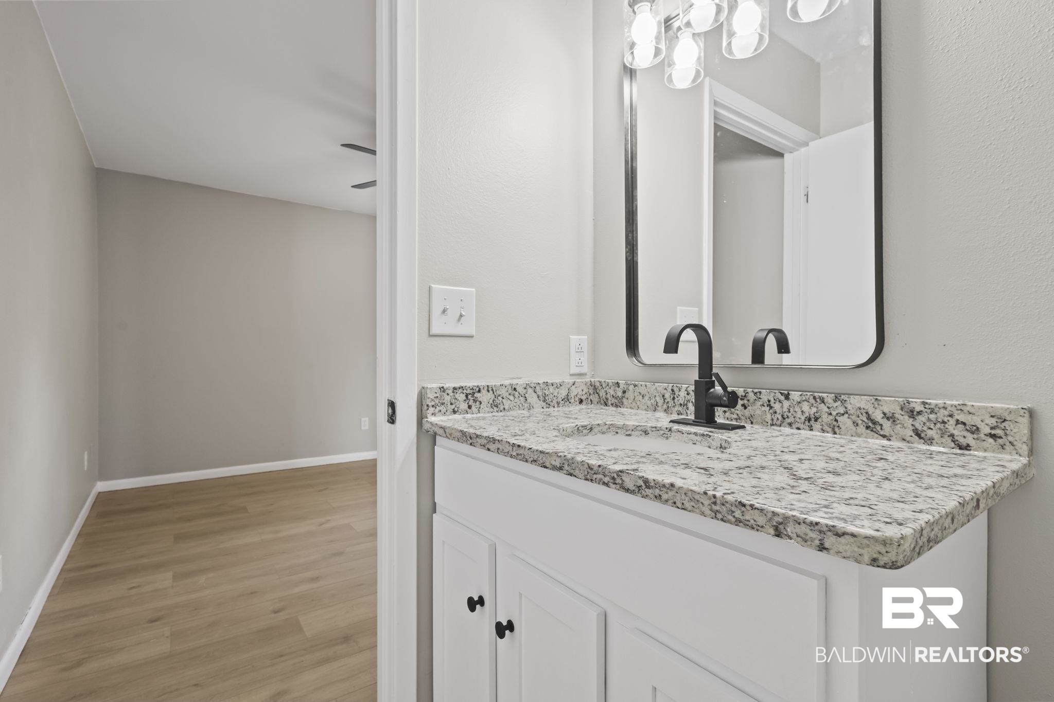 309 West Roosevelt Avenue Foley, AL 36535 - Photo 13 of 60 Bathroom featuring ceiling fan, vanity, and wood-type flooring