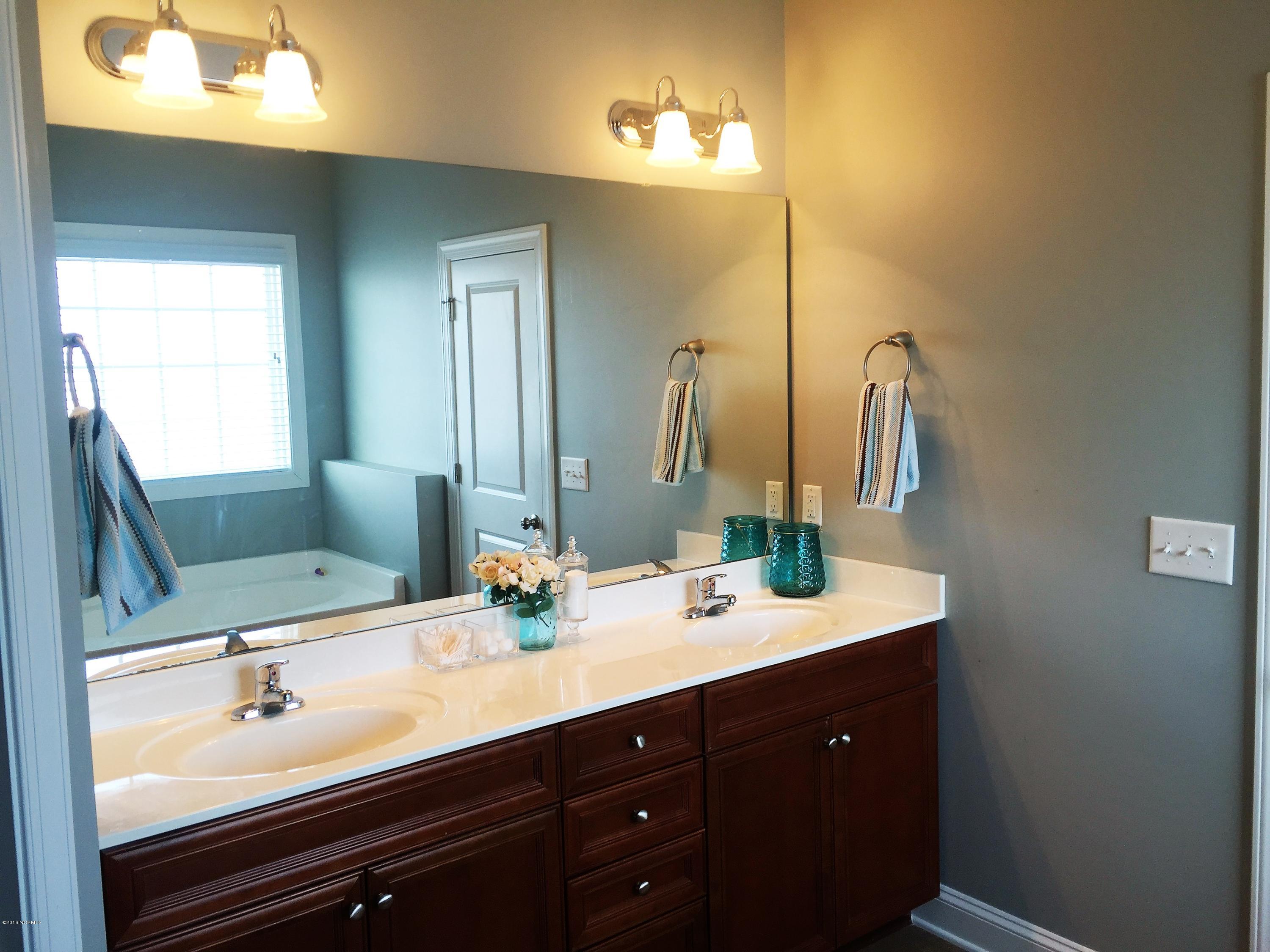 109 Bethea Street Holly Ridge, NC 28445 - Photo 23 of 37 Master bath with huge walk in closet as well as access to the laundry room from the master closet or the hallway.