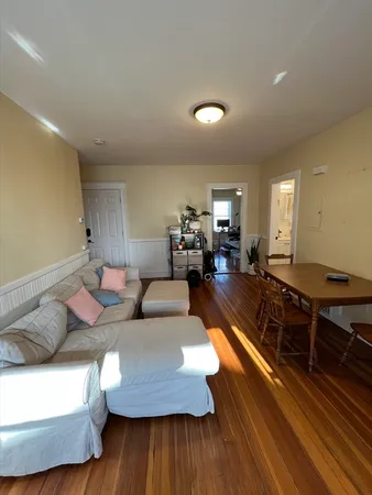 a living room with furniture rug and wooden floor