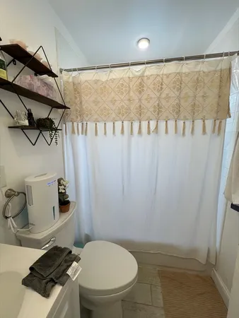 a bathroom with a toilet and a shower