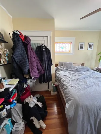 a bedroom with a bed and a window