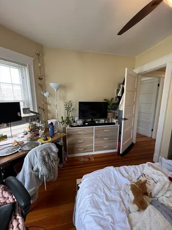 a bedroom with furniture and a flat screen tv