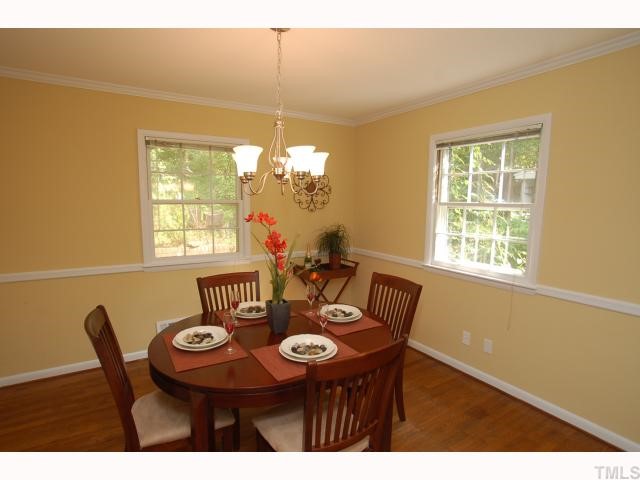 731 Davidson Street Raleigh, NC 27609 - Photo 5 of 10 Dining room has hardwood floors, chair and crown molding, new paint and new light fixture