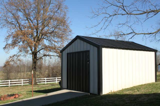 101 Maple Street Adams, TN 37010 - Photo 14 of 15 The storage building remains with the home and offers a great option for lawn tools and the mower. The concrete ramp makes it easy to store the motorized yard tools and toys.
