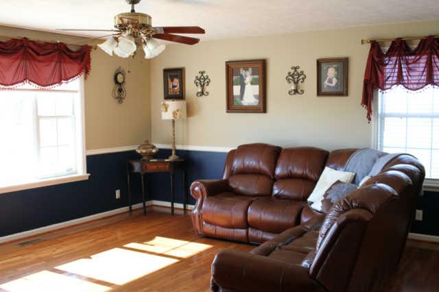 101 Maple Street Adams, TN 37010 - Photo 3 of 15 The large living area is flooded by natural light flowing through the large windows. The great room offers ample room for large furnishings and is perfect for entertaining as it adjoins the dining area. The covered deck is just outside the dining.
