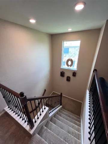 a spacious bedroom with a bed and a window