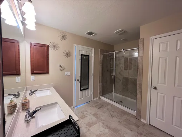 a bathroom with a tub sink and mirror