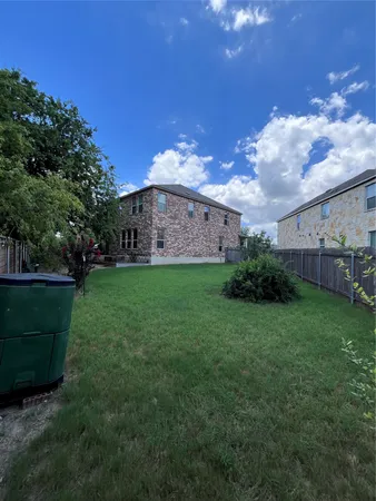 a view of a patio with table and chairs and potted plants